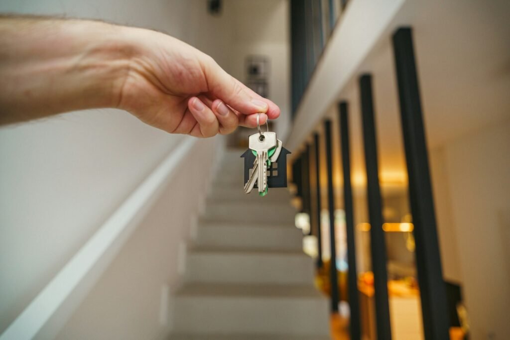 A hand holding house keys
